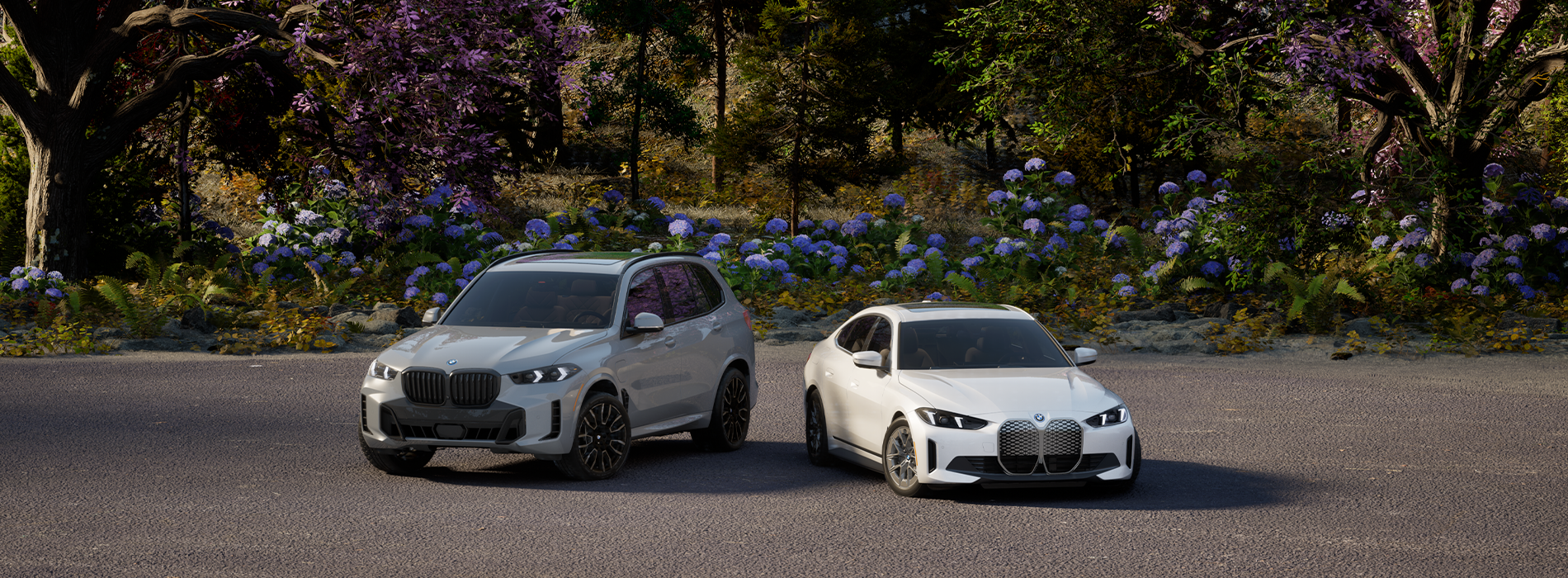 Vehículos eléctricos BMW aparcados en un paisaje primaveral.